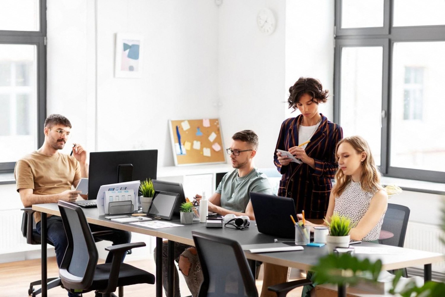 Small UAE business team planning multi-emirate operations in a bright office